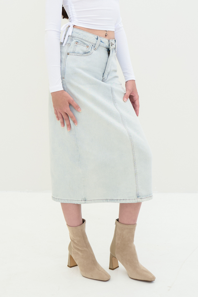 A woman wearing a light blue denim skirt. Front image.