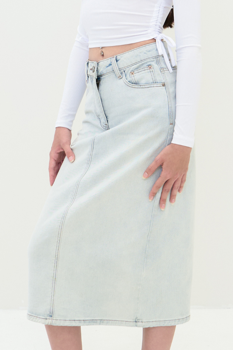 A woman wearing a light blue denim skirt. Front image. Close up side image styling.