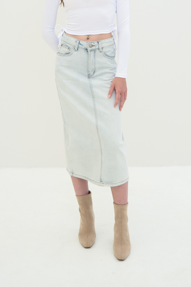 A woman wearing a light blue denim skirt. Close up image.