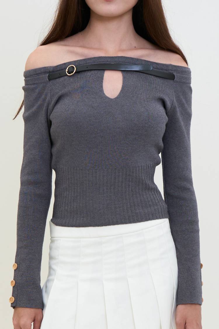Gray off-shoulder sweater with cut-out design worn by a person on a white background. Gray off-shoulder sweater blouse worn by a woman with long hair against a white background. MIYAA top Women’s Long sleeve off-shoulder sweater blouse. Fashion gray top. Front close up image.