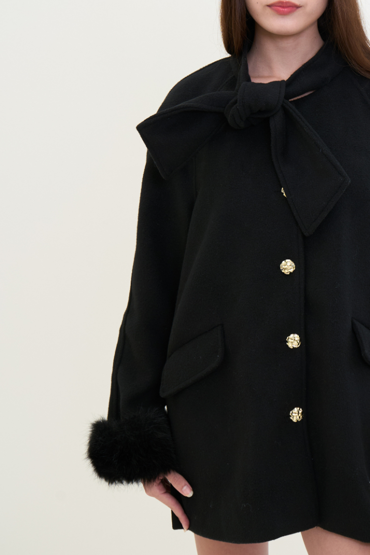 Black coat with gold buttons and fur trim on a white background. Black coat with fur cuffs and gold buttons. NOOR coat Women’s back coat. Wool, Combined Cotton, Vegan Fur.
