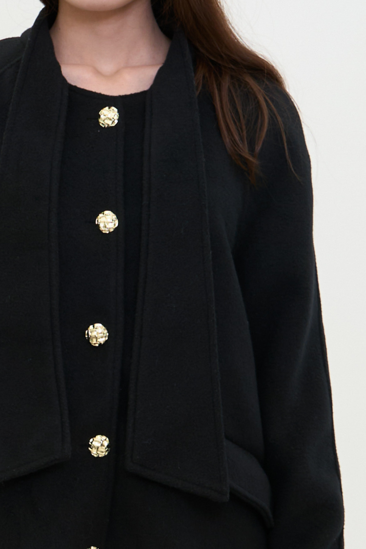 Black coat with fur cuffs and gold buttons. NOOR coat Women’s back coat. Wool, Combined Cotton, Vegan Fur. Right side close up image.