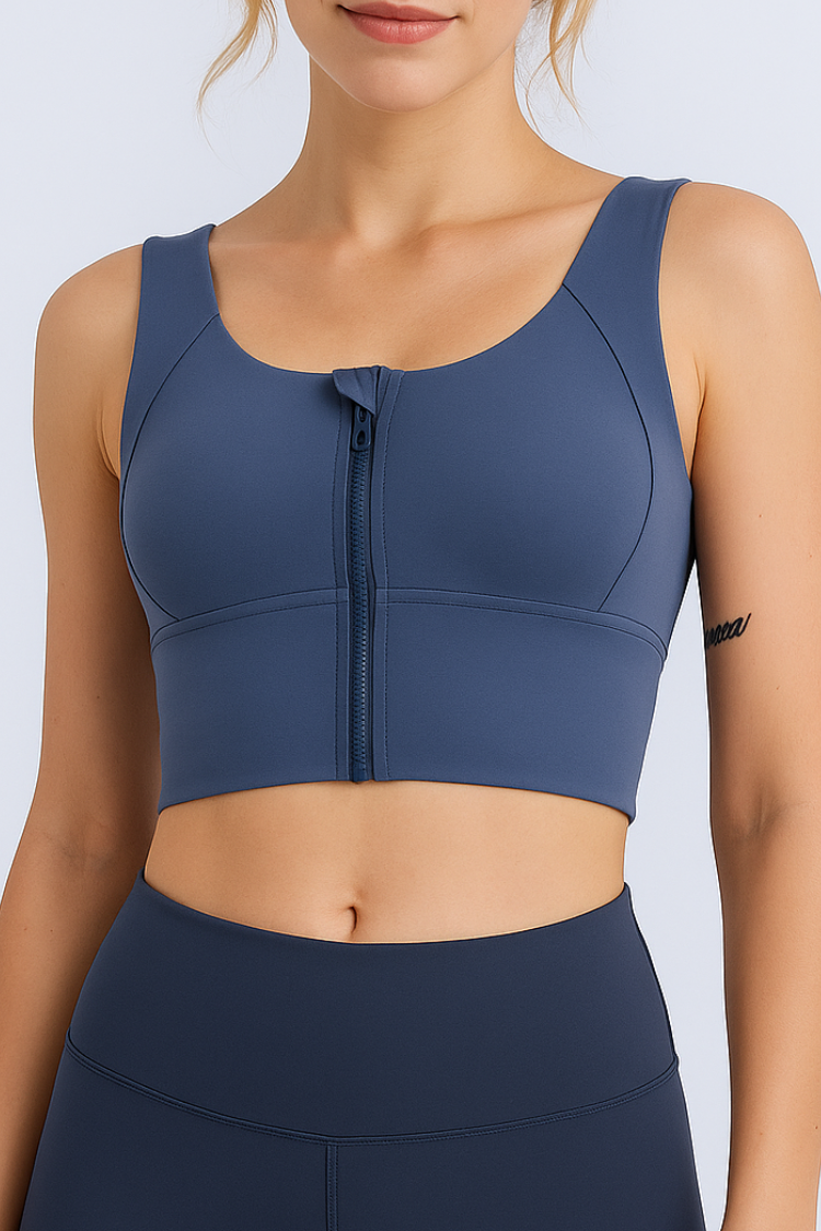 Navy blue sports bra with a zipper on a light gray background. Women’s Navy blue sports bra with a zipper. Women’s high impact sports bra. Nike sports bra. best sports bra. Woman's athletic wear. Active wear. yoga top.