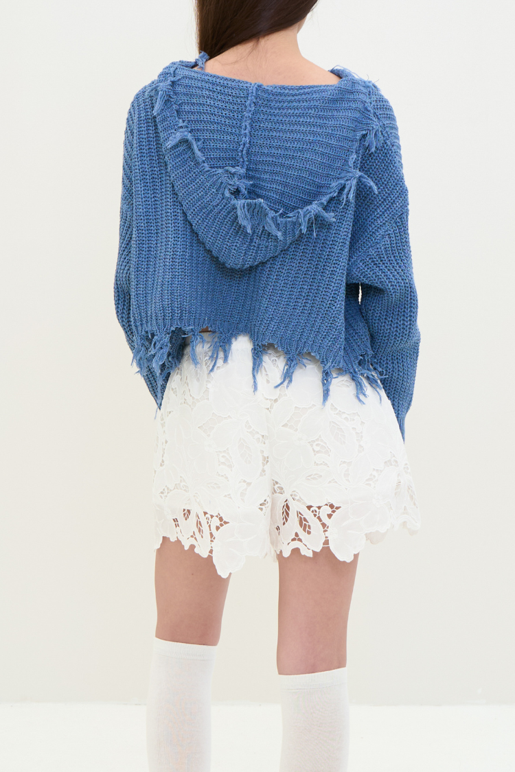 A women wearing white lace shorts. Women’s white lace shorts. Women's shorts Floral design and water resistance. Back image.