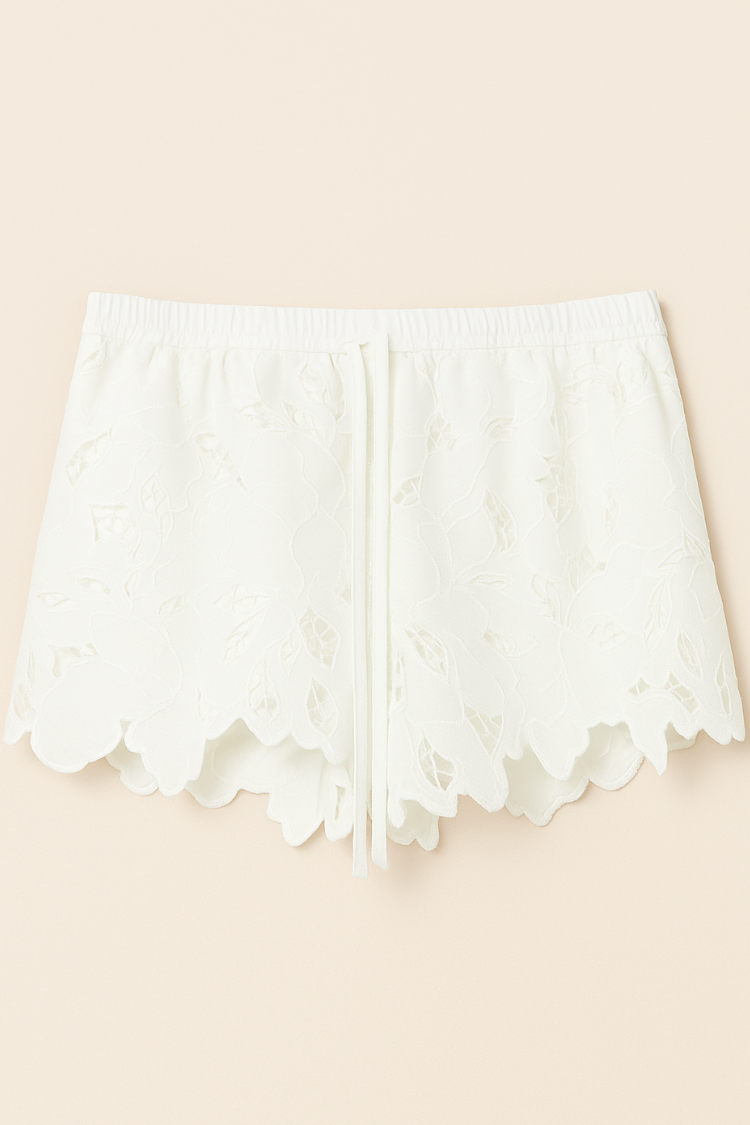 A women wearing white lace shorts. Women’s white lace shorts. Women's shorts Floral design and water resistance. Image display.