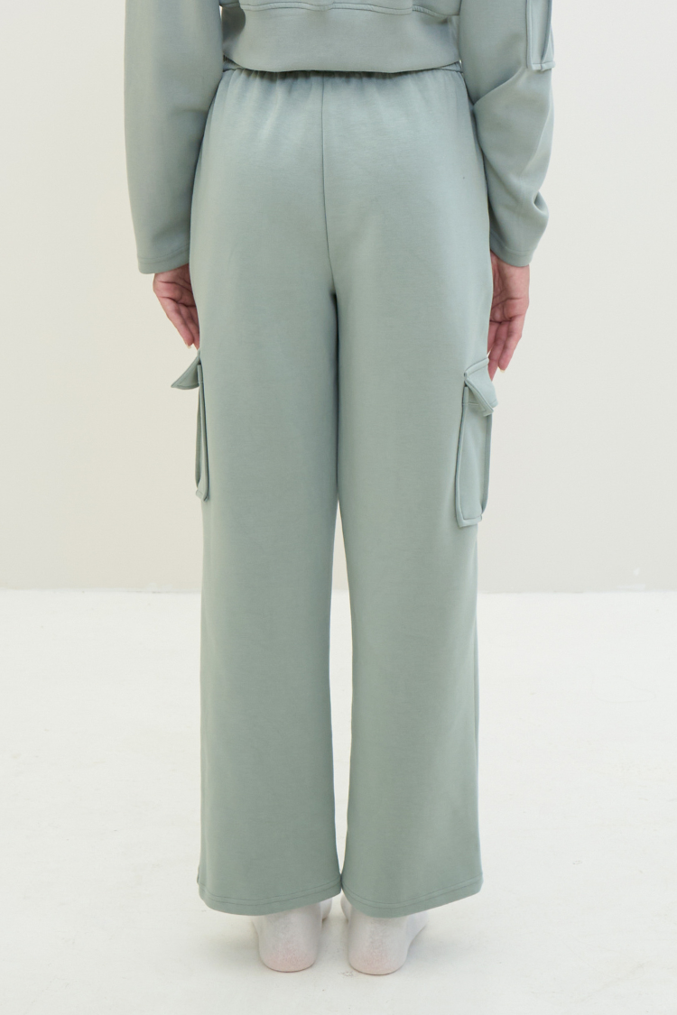 Light green outfit with wide-leg pants and a matching top on a white background. ELOWEN sports set 1 - Track suit zipper sweater and sweatpants Active wear front display. Women wearing a mint light green color tracksuit.