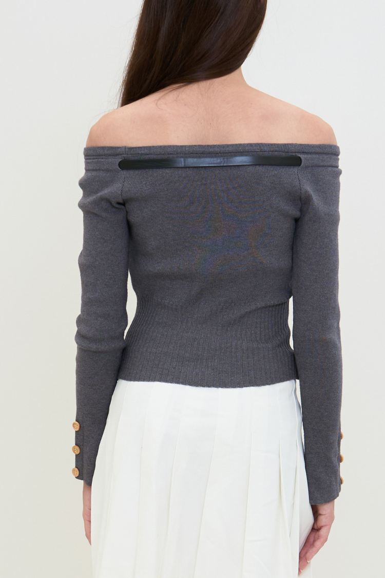 Gray off-shoulder sweater with gold buttons worn by a woman on a white background. Gray off-shoulder sweater blouse worn by a woman with long hair against a white background. MIYAA top Women’s Long sleeve off-shoulder sweater blouse. Fashion gray top.