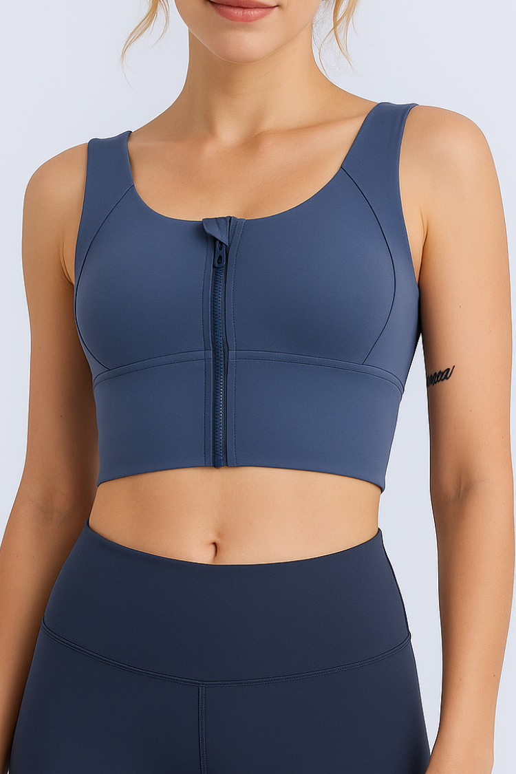 Women’s Navy blue sports bra with a zipper. Women’s high impact sports bra. Nike sports bra. best sports bra. Woman's athletic wear. Active wear. yoga top. Front image.