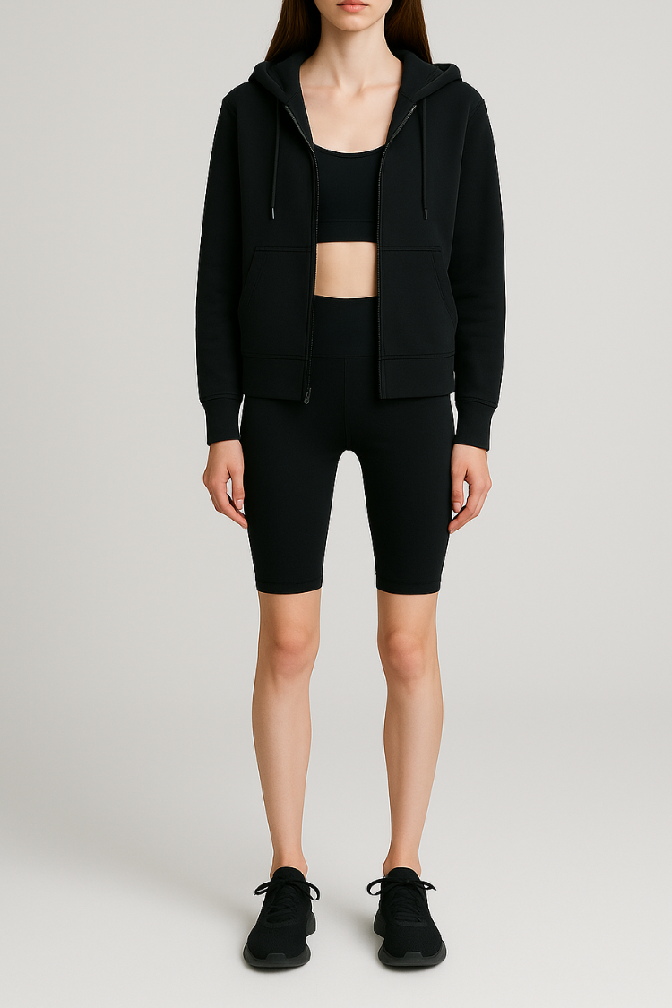 Person wearing a black hoodie and black athletic shorts on a light gray background. biker shorts short leggings women's short leggings yoga legging 2